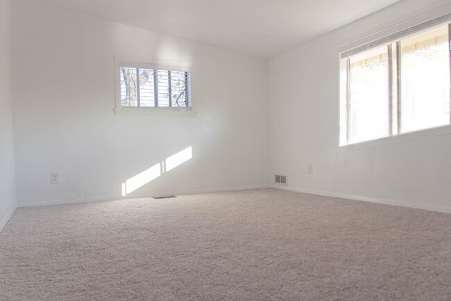 Upstairs bedroom with new windows and new windows and modern, energy efficient cellular shades. - 100 Beaver St