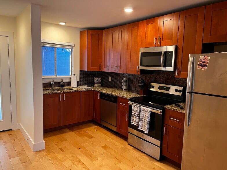 A kitchen with plenty of counter space and natural lighting. - 909 Reinli St