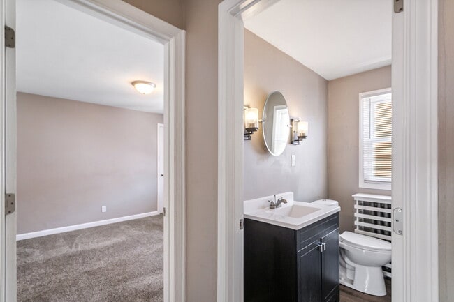 Building Photo - This spacious upper unit features 2 comfortable bedrooms with carpeting