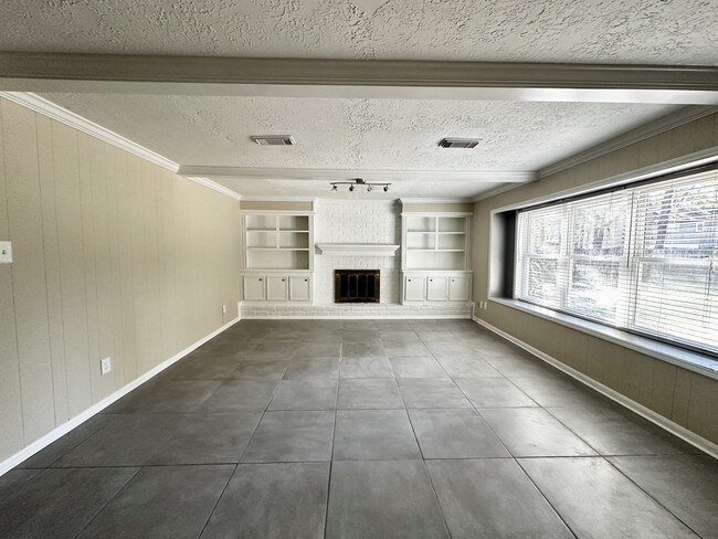 Main Living room with shelves and fireplace - 15231 Highsprings Dr