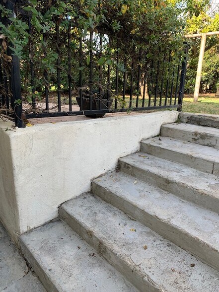Steps down to front entrance. Unit is partially underground in the front but property slopes down. - 24606 University Ave
