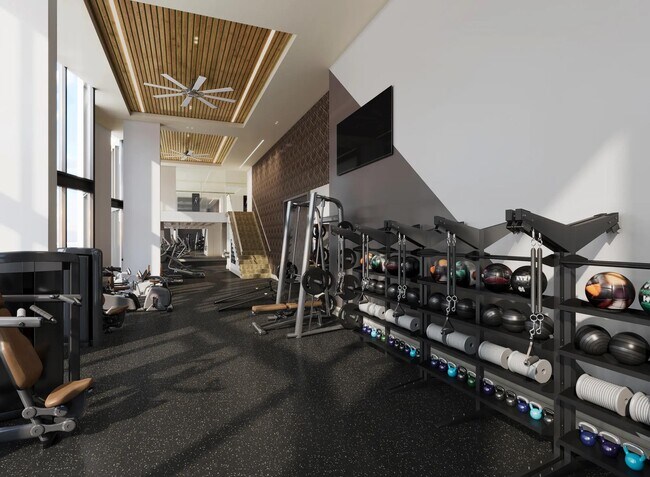 24/7 club-quality fitness studio with TRX system, spin bikes, and activity lawn at Modera McGavock in Nashville, TN. - Modera McGavock