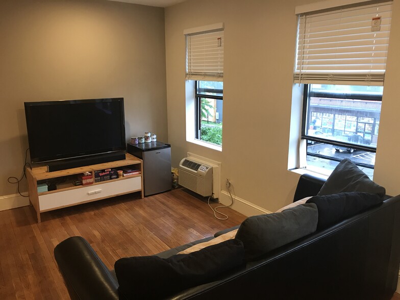 Open floor plan- furnished living room with sofa and entertainment center - 3719 12th St NE