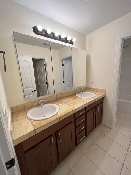 Master bathroom with double vanity and mirrored medicine cabinet - 21078 NE 15th St