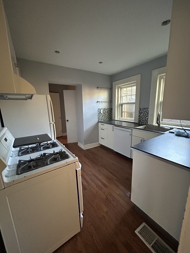 Kitchen, pantry and laundry room in back. - 1048 28th St S