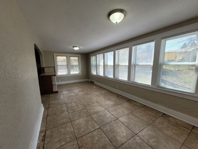 Building Photo - Four bedroom home on Indianola Ave with large yard and two decks!