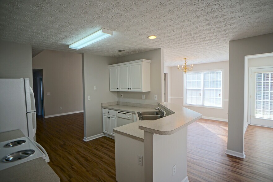 Kitchen is open to breakfast nook and formal dining room - 11 Spring Valley Cove