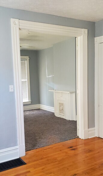 Front room carpet with ceiling fan, adjacent room hardwood floor for office or studeo - 133 S 7th St