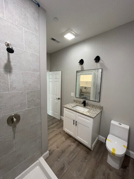 Unit two: bathroom (*brand new sliding class shower doors have been installed) with laundry space an - 34 Falcon St