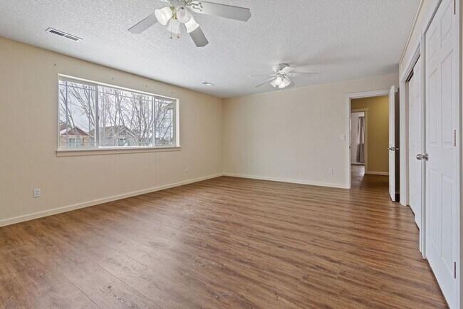 Building Photo - SPACIOUS LAYOUT! HARD SURFACE FLOORING, FENCED YARD & LARGE PATIO!
