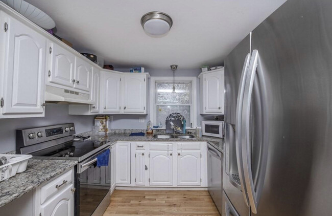 Kitchen, stainless steel appliances and electric oven and cooktop - 647 N Main St