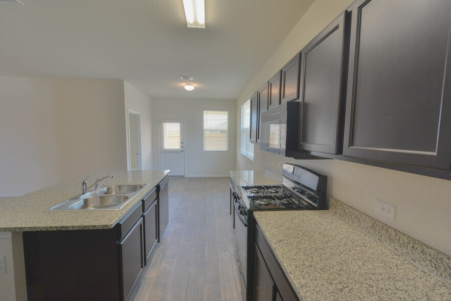 Kitchen with breakfast nook. Gas stove, refrigerator, microwave, dishwasher, and disposal included. *light fixtures will be replaced* - 3702 Chappie Lane