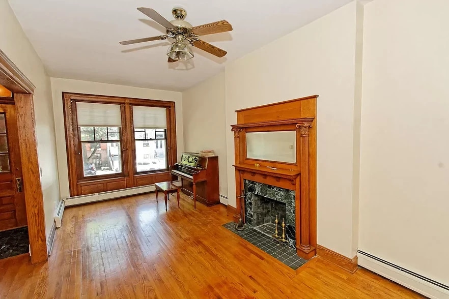 piano not included, look at all that sunlight. Fireplace does not work, but it looks spiffy. - 342 Hudson Ave