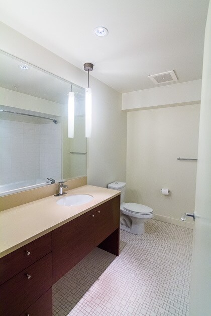 Roomy bathroom with tile floor, large mirror, and spacious counter-top. - 3601 SW River Pkwy