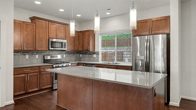 Building Photo - Brightview 4-Bedroom with Main-Floor Bedroom, 3-Car Garage, and Exceptional Outdoor Space
