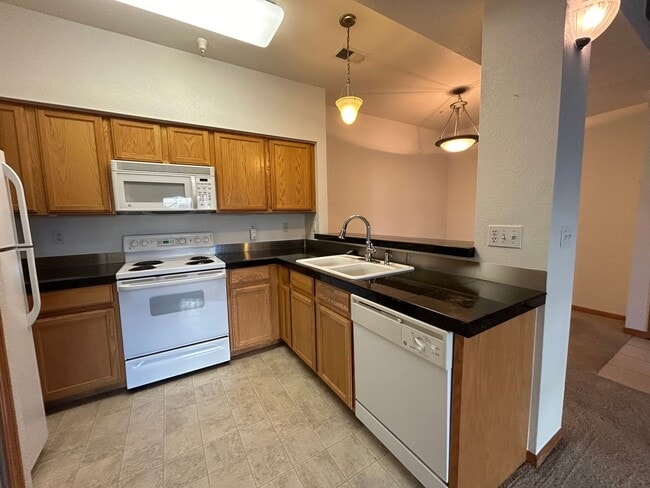 Building Photo - Bright 2-Bed Condo with Vaulted Ceilings, Garage & Balcony