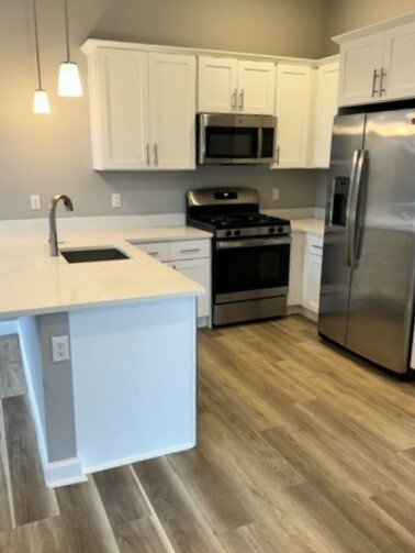 Tasteful Galley Kitchen Comes Equipped with Quartz Counters, SS Appliances & Wood Cabinetry - 271 Millburn Ave