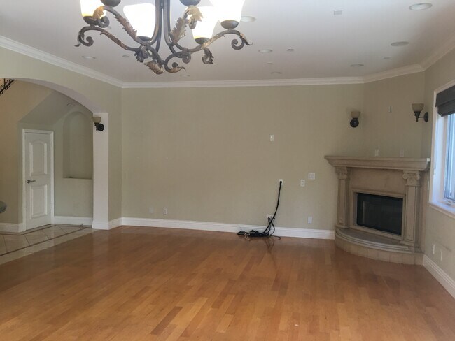 Living room with fireplace. - 1540 S Bentley Ave