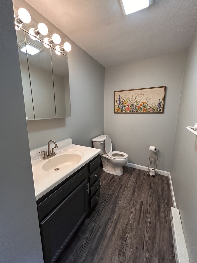 Downstairs half bath with updated hardware, flooring and paint. - 252 Union St