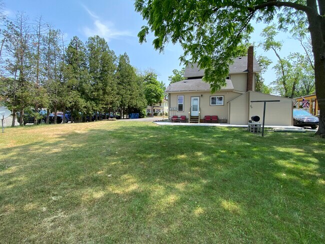 Back yard showing clothes line; Unit 3 patio and grill. - 309 N Davison St