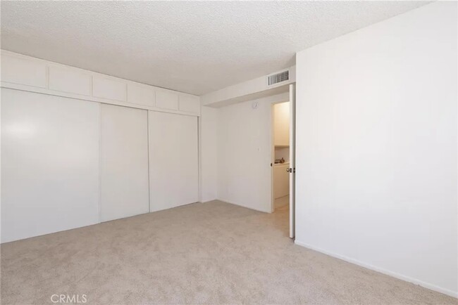 bedroom with wall to wall closet space - 7301 Lennox Ave