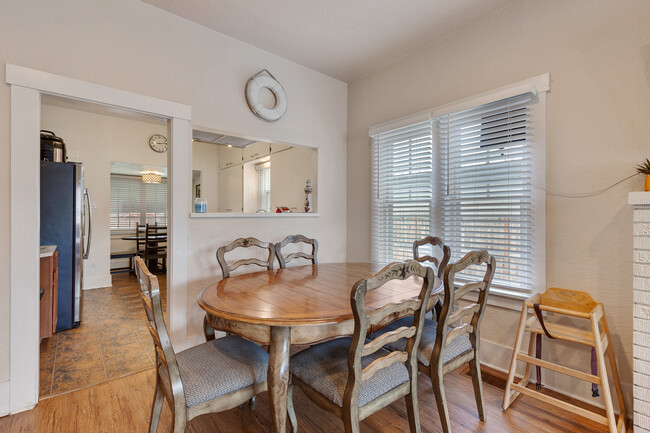 Dinning table and view into kitchen pass through. - 717 E Lakeside Ave