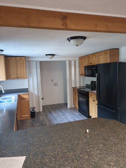 Kitchen off living room with laundry closet - 1871 SE Van Skiver Rd