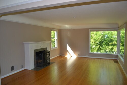 Beautiful natural light as seen in the living room. Fireplace is now gas. - 9121 SW 35th Ave