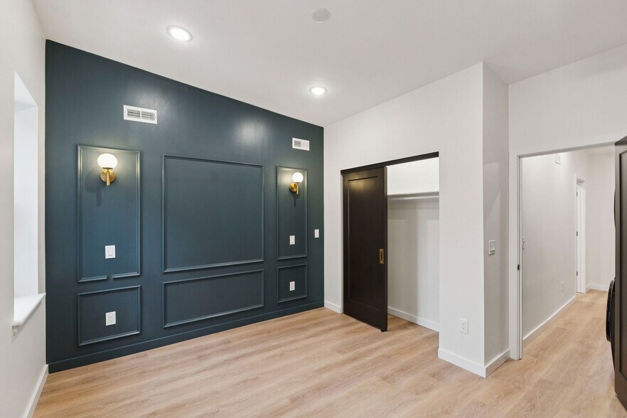 Primary bedroom with exposed brick and bedside lighting - 1544 S Bambrey St
