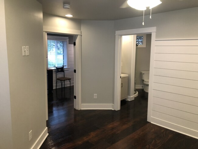 View from primary bedroom back toward the kitchen and into the ensuite bathroom - 20400 Church St