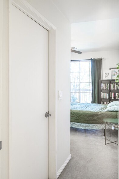 Bedroom 2 entry with walk in closet organizers and powered outlet! door - 10021 Tabor Street