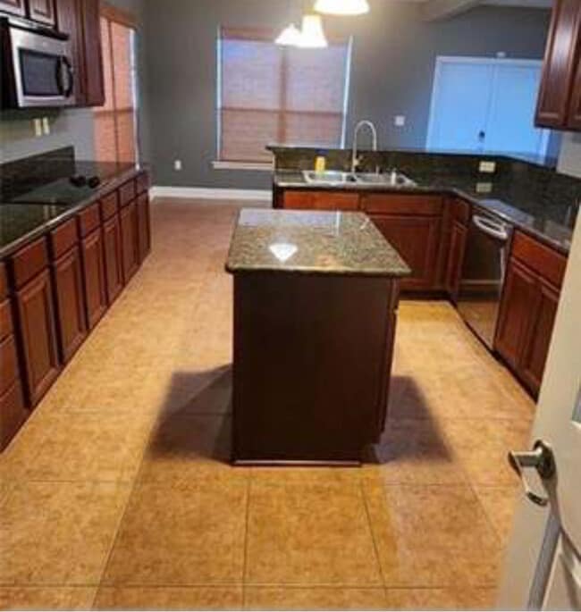 Beautiful kitchen with all new cabinets and granite countertops. Refrigerator and stove included. - 39152 Cajun Bayou Ave