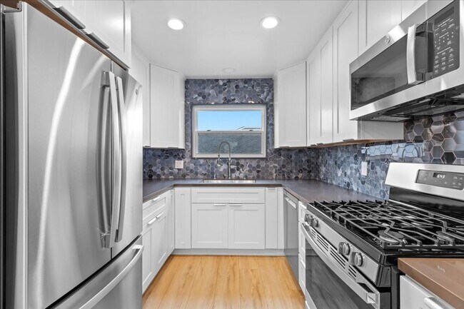 Building Photo - COMPLETELY REMODELED, BRIGHT & AIRY, TRI-LEVEL HOME W/ TOP-FLOOR GREAT ROOM LIVING SPACE, 2-CAR G...