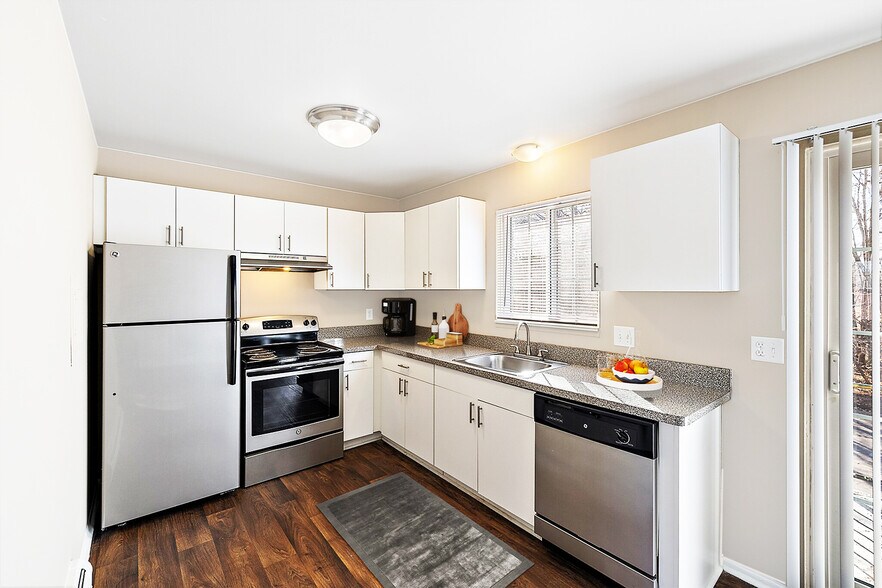Large gourmet kitchen with trendy white cabinetry, granite countertops, stainless steel appliances, window on the world. - The Gables of Troy