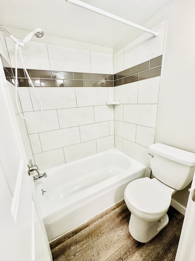 Immerse in comfort with this stylish, contemporary bathroom layout. - Hawk Point Apartments