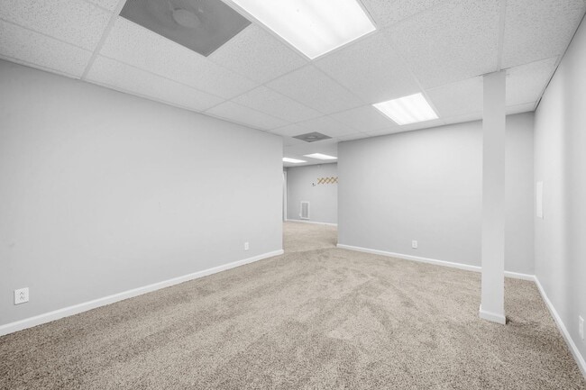 Building Photo - Stunning Stone Fireplace • Finished Basement • Fenced Yard