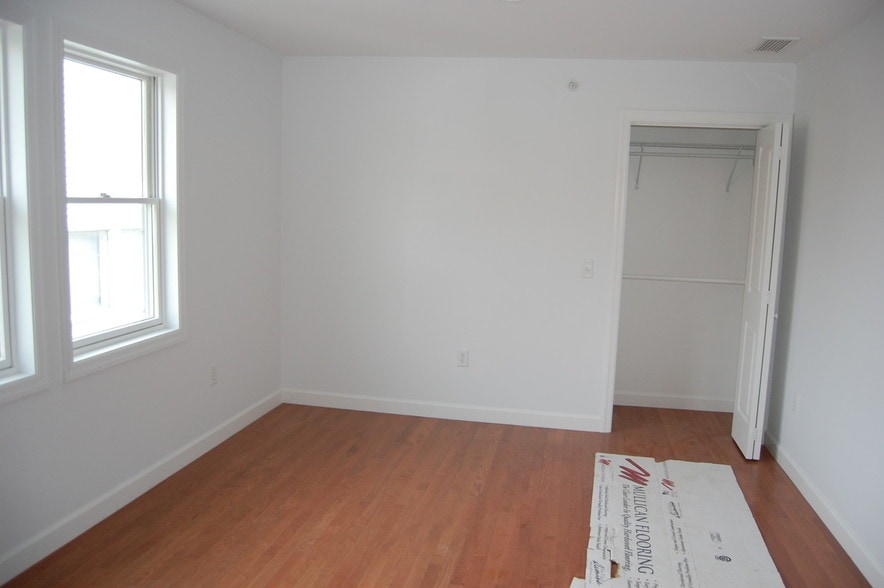 Extra large bedroom with extensive storage and door to laundry. - 485 Elmwood Ave