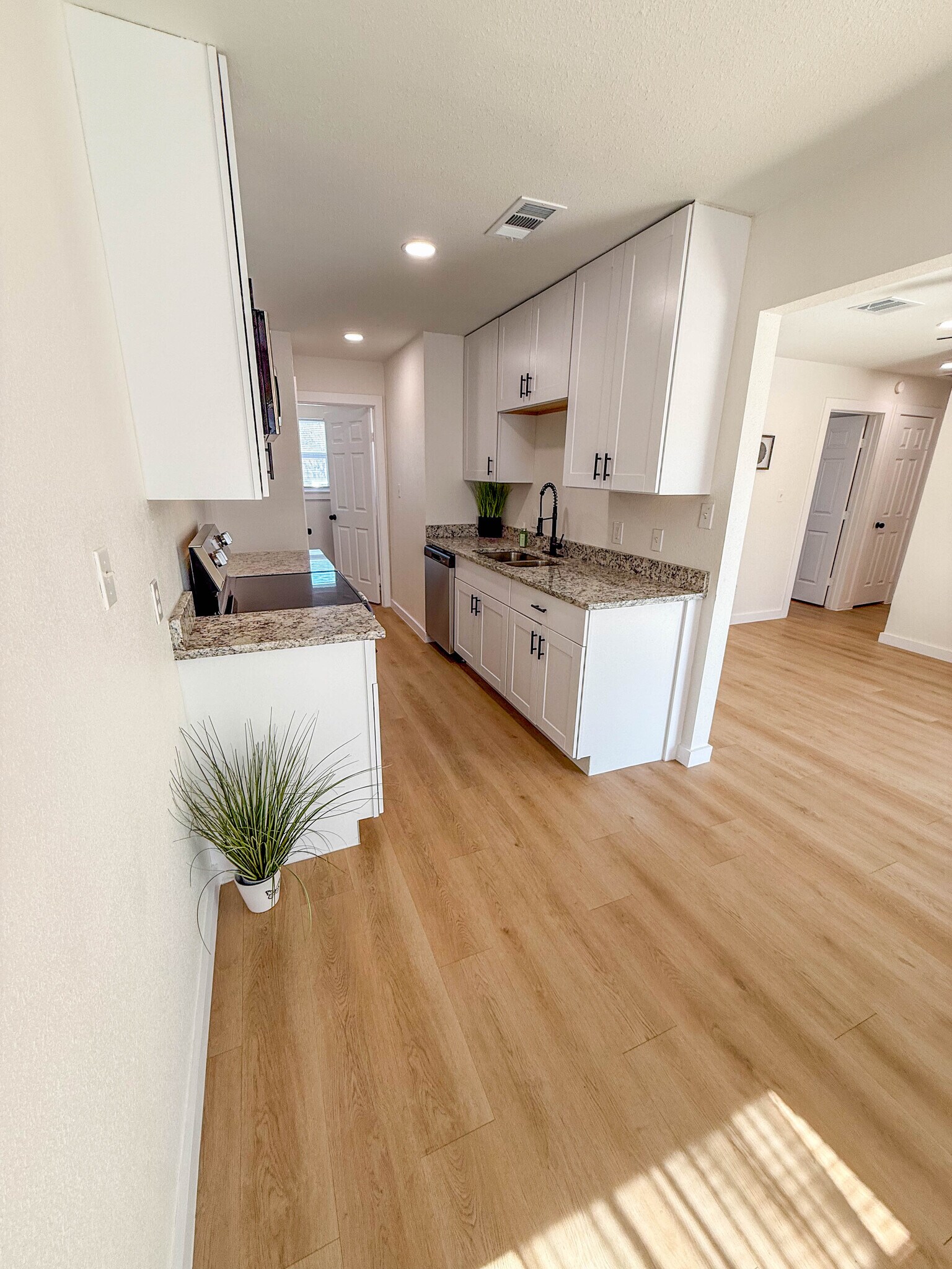 Kitchen leads into separate laundry room. - 308 E Bourn St