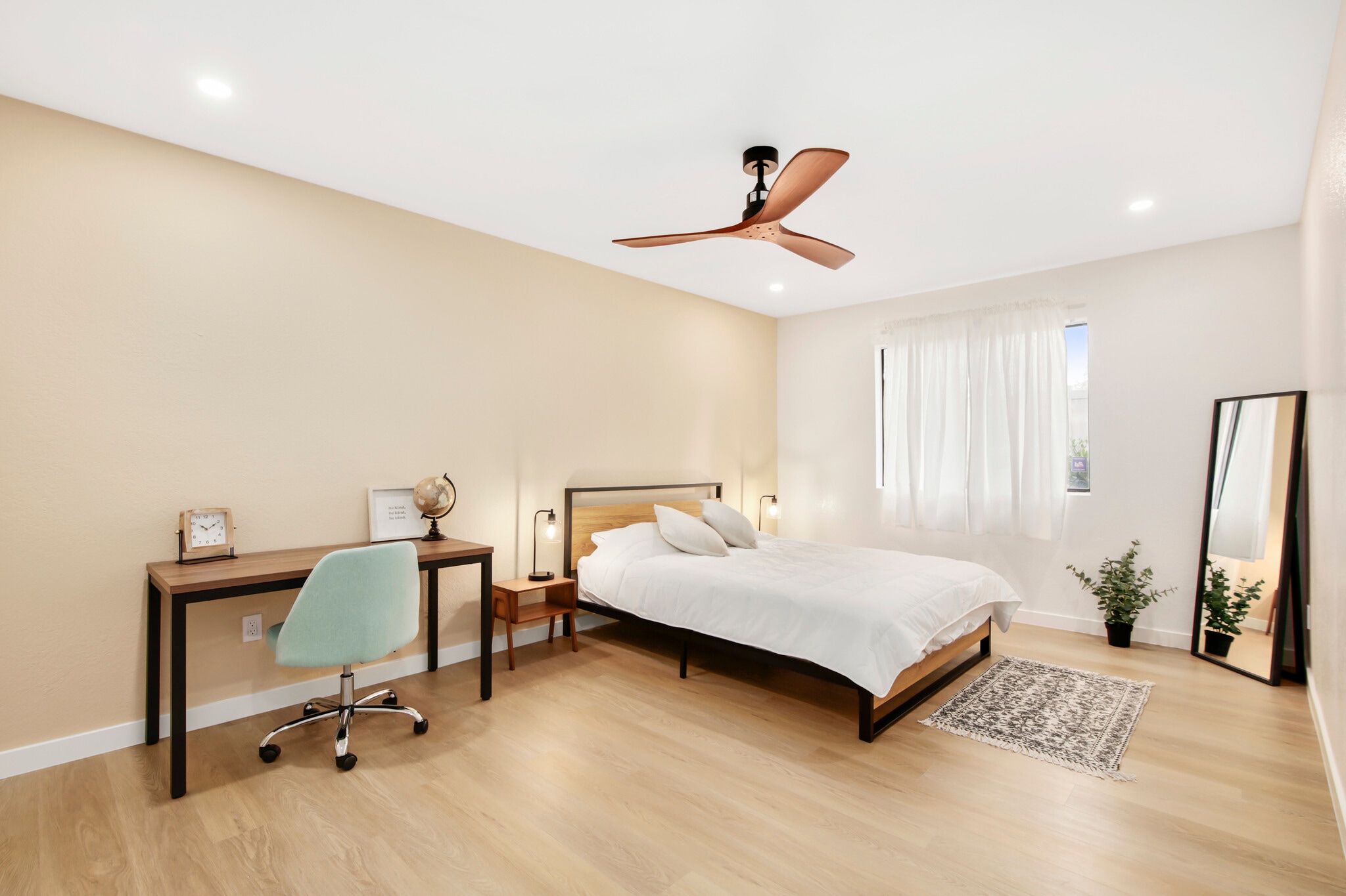 Sunny bedroom with ceiling fan, soft tones, and a cozy, peaceful atmosphere. - 1013 S Sunshine Ave