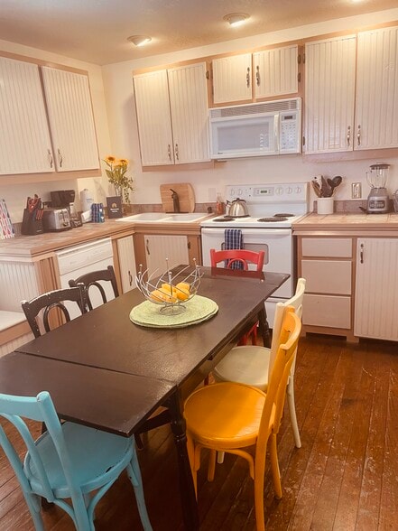 Antique table pulls out to accommodate up to 6 plus the bench seating behind - 541 E Jones Ln