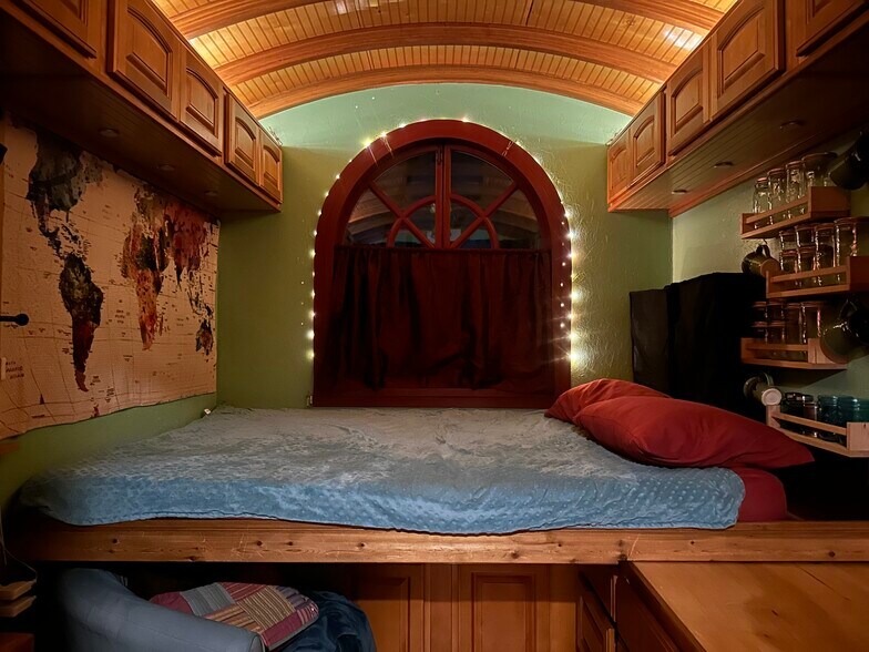 The bed pulled out over the countertop in nighttime mode creates a cozy haven for sleep. - 833 Valencia St