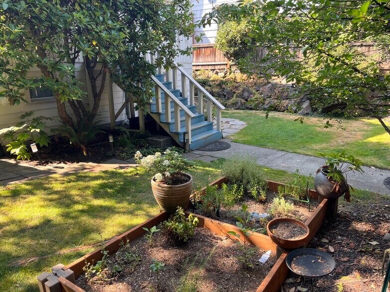 Your private yard features a garden and your very own cherry tree. - 5211 Fauntleroy Way SW