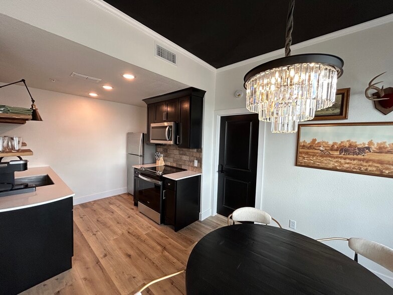 Beautiful dining room overlooks Downtown Stephenville through expansive custom windows - 221 E College St