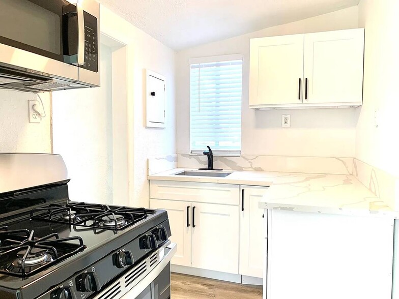 Gas Range, Quartz Counters, Shaker Cabinets - 3486 National Ave