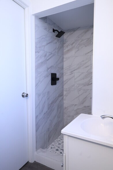 Tiled Shower: A brand-new, designer-tiled walk-in shower. - 9104 Baltimore St