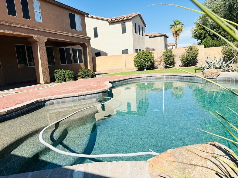 Private PebbleTec pool with a water feature; pool service included. - 1177 W Laredo Ave