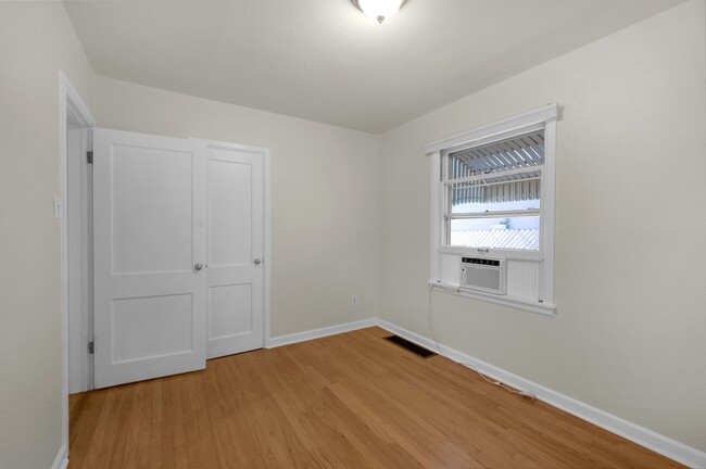 Another view of bedroom 1 with closet and hardwood. - 114 N Foote Ave