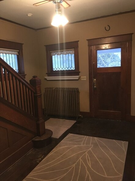 Foyer area, front entry to porch. Shows the great woodwork that has been saved on this beautiful staircase. Leaded glass windows, with outer storms for added insulation - 1545 S 13th St