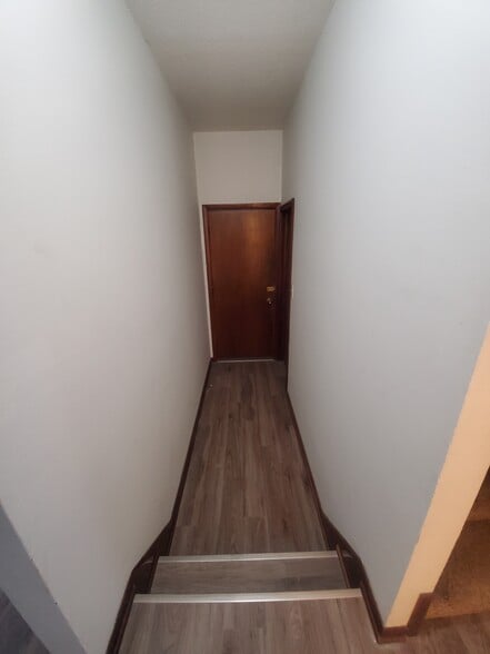 Hallway is located in between Kitchen and Livingroom. this leads to the attached garage or on the right-hand side leads to the basement - 1182 Lane Pl