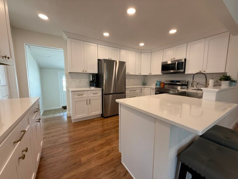 The kitchen is open to the main living and dining space. All new surfaces and appliances! - 129 36th Ave NE